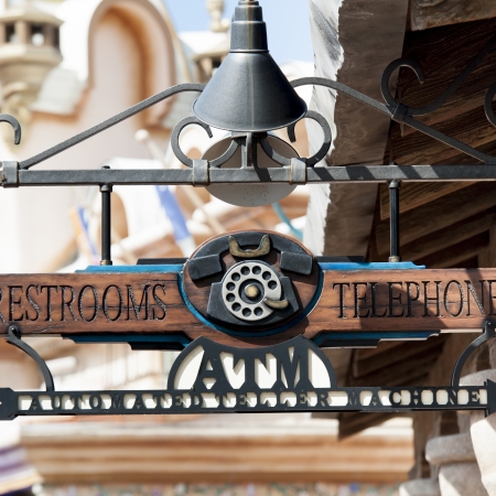Close-up of Restroom and Telephone Booth signs, Universal Studios, Orlando, Florida, USAのeditorial素材