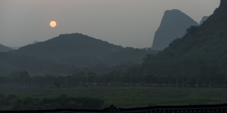 Sunset over mountain, Yangshuo, Guilin, Guangxi Province, Chinaの写真素材