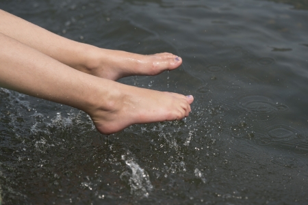 Girl splashing water with her feet, Li River, Yangshuo, Guilin, Guangxi Province, Chinaの写真素材