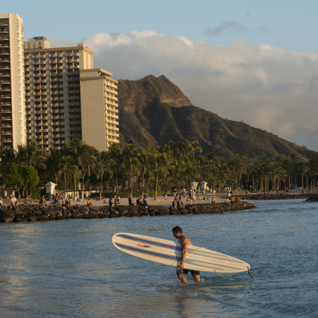 Surfer on the beach with Diamond Head in background, Waikiki, Honolulu, Oahu, Hawaii, USAのeditorial素材