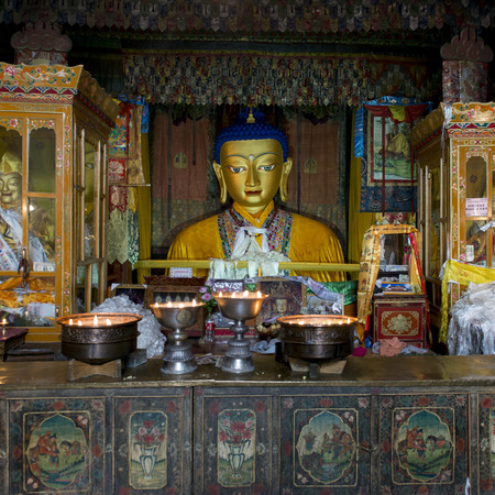 Votive candles burning in front of Buddha statue in Drepung Monastery, Lhasa, Tibet, Chinaのeditorial素材