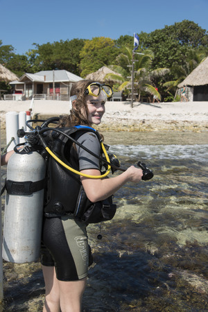 Scuba diver standing on the beach, Utila Island, Bay Islands, Hondurasのeditorial素材