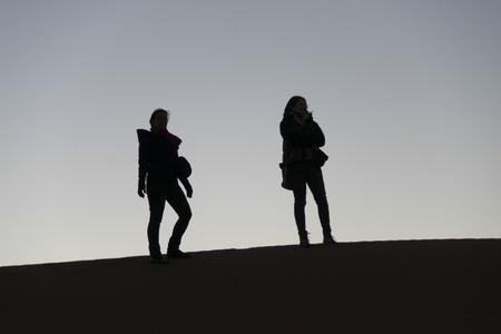 Women standing on Erg Chegaga Dunes in Sahara Desert, Souss-Massa-Draa, Moroccoの写真素材