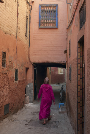 Woman walking in an alley, Marrakesh, Moroccoの写真素材