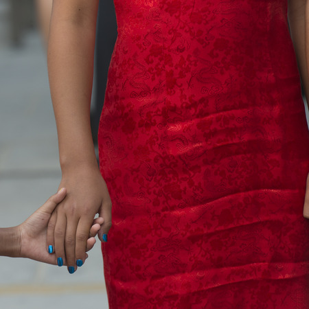 Mid section view of a woman holding hand of her child, Changping District, Beijing, Chinaの写真素材