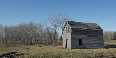 Old abandoned barn in a field, Manitoba, Canadaの写真素材