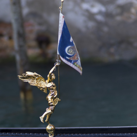 Angel statue with flag on gondola, Grand Canal, Venice, Veneto, Italyの写真素材