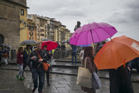 People walking on city street during rain, Ponte Vecchio, Florence, Tuscany, Italyのeditorial素材