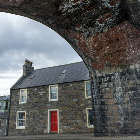 View of houses along street, Cullen, Moray, Scottish Highlands, Scotlandの写真素材