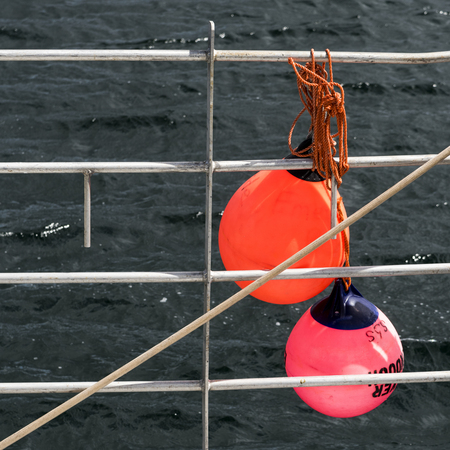 Buoys hanging on railing in harbor, West Dover, Halifax, Nova Scotia, Canadaの写真素材