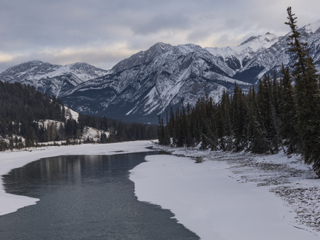 Frozen lake with mountain range in the background, Maligne Lake, Highway 16, Yellowhead Highway, Jasper, Jasper National Park, Alberta, Canadaの写真素材