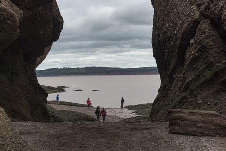 Tourists on beach at Hopewell Rocks, Bay of Fundy, New Brunswick, Canadaのeditorial素材