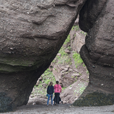 Tourists on beach at Hopewell Rocks, Bay of Fundy, New Brunswick, Canadaの写真素材