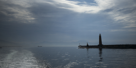 Scenic view of lighthouse by sea, Naples, Campania, Italyの写真素材