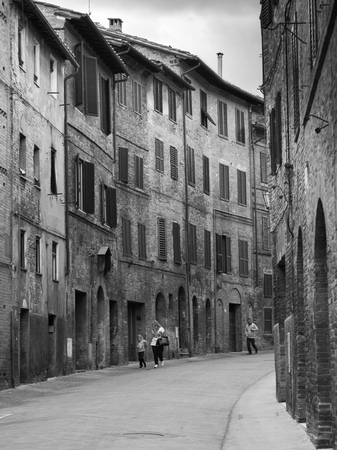 People walking on street amidst buildings, Siena, Tuscany, Italyのeditorial素材