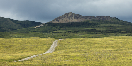 Country road passing through landscape, Bison Paddock, Waterton Lakes National Park, Southern Alberta, Alberta, Canadaの写真素材