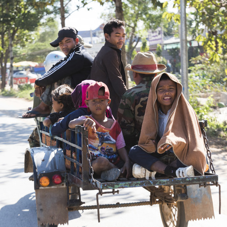 People sitting in cart moving on road, Krong Siem Reap, Siem Reap, Cambodiaのeditorial素材
