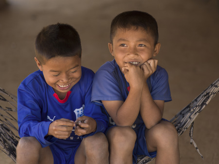 Happy boys sitting on a hammock, Ban Houy Phalam, Laosのeditorial素材
