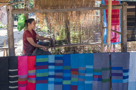 Woman weaving shawls on loom, Laosのeditorial素材