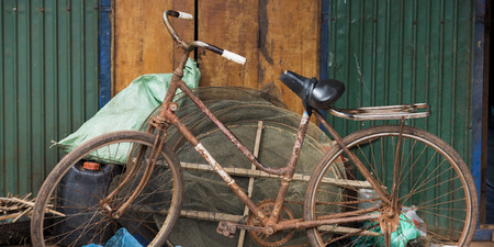 Rusted bicycle leaning against fishing nets, Siem Reap, Cambodiaの写真素材