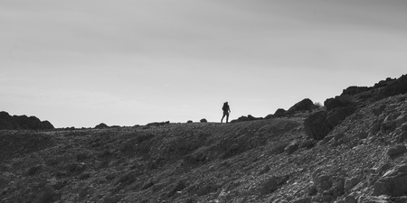 Hiker walking in desert, En Gedi Nature Reserve, Judean Desert, Dead Sea Region, Israelの写真素材