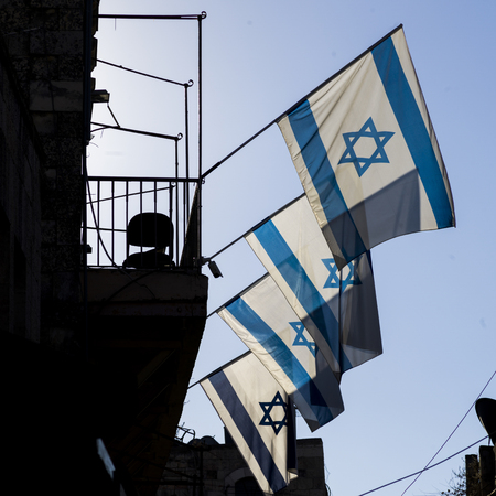 Low angle view of Israeli Flags on building in the Old City of Jerusalem, Israelの写真素材