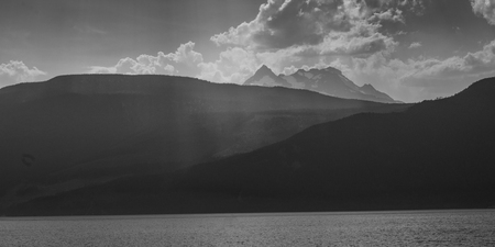 Lake with mountain range in the background, Kootenay Lake, British Columbia, Canadaの写真素材