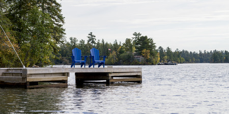 Adirondack chairs on a dock, Kenora, Lake of The Woods, Ontario, Canadaの写真素材