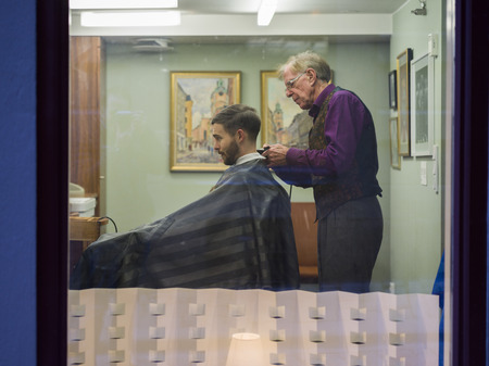 Barber cutting a man's hair, Gamla Stan, Stockholm, Swedenのeditorial素材