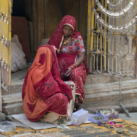 Women selling craft products in street market, Kishan Ghat, Jaisalmer Fort, Jaisalmer, Rajasthan,...