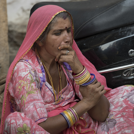 Native woman sitting near scooter, Jaisalmer Fort, Jaisalmer, Rajasthan, Indiaのeditorial素材