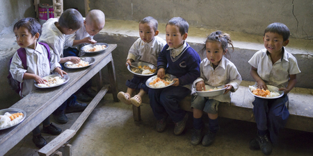 School children having mid-day meal in school, Radhu Khandu Village, Sikkim, Indiaのeditorial素材