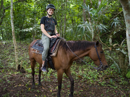 Woman riding horse, Chaa Creek Road, Chaa Creek Nature Reserve, San Ignacio, Belizeのeditorial素材