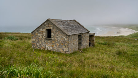Abandoned building along coastline, Mullet Peninsula, Binghamstown, Erris, County Mayo, Irelandのeditorial素材