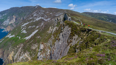 Tourists walking on hill, Slieve League, County Donegal, Irelandのeditorial素材