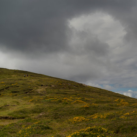 View of hikers seen on hill, Brandon Point, Murirrigane, Brandon, County Kerry, Irelandのeditorial素材