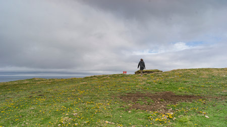 Woman walking on a landscape, Downpatrick Head, Killala, County Mayo, Irelandのeditorial素材