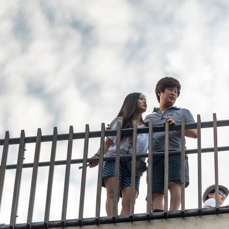 Low angle view of couple standing near railing, Seoul, South Koreaのeditorial素材