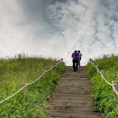 Two people running up steps in park, Seoul, South Koreaのeditorial素材