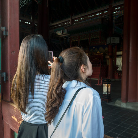 Women at Geunjeongjeon Building, Gyeongbokgung Palace, Seoul, South Koreaのeditorial素材