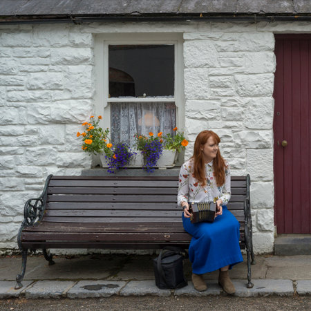Woman playing Squeezebox outside store, Bunratty, County Clare, Republic of Irelandのeditorial素材