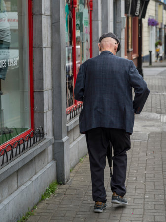 Rear view of senior man walking on street, Galway City, County Galway, Irelandのeditorial素材