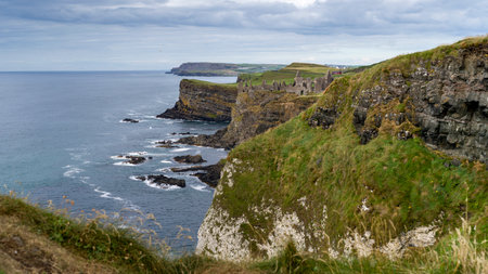 Ruins of medieval Dunluce Castle on the cliff, County Antrim, Northern Ireland, Irelandのeditorial素材