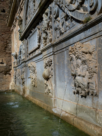 Gargoyle fountain against stone wall of palace, Alhambra, Granada, Spainのeditorial素材