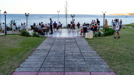 Tourists at seaside cafï¿½, Malecon, Havana, Cubaのeditorial素材