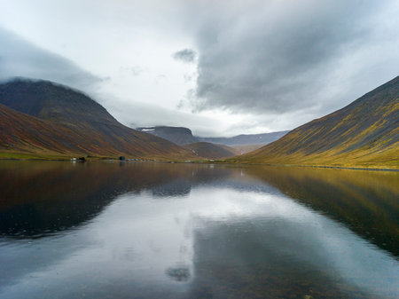 Reflection of hill on water, Isafjorour, Isafjaroarbaer, Westfjords Region, Icelandのeditorial素材