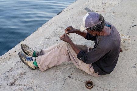 Fisherman sitting at the seaside, Malecon, Havana, Cuba