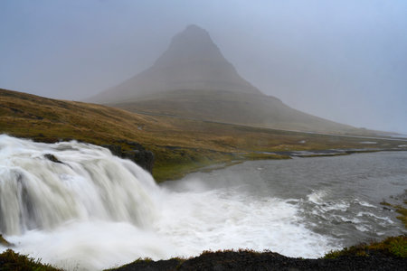 Kirkjufellsfoss Waterfall with Kirkjufell mountain peak in the background, Reykholahreppur, Westfjords, Icelandのeditorial素材