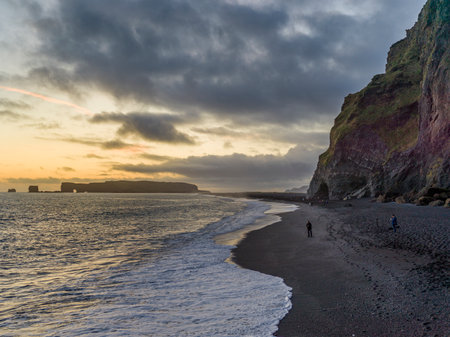 Tourists on the beach, Reynisfjara Black Sand Beach, Myrdalshreppur, Southern Region, Icelandのeditorial素材