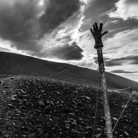 Glove on a pole with clouds over volcanic landscape, Hverfjall, Skutustaoahreppur, Northeastern Region, Icelandのeditorial素材